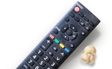 Black remote control next to a piece of popcorn