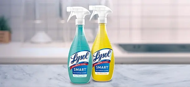 Bottles of Lysol Smart Multi Purpose Cleaner on a kitchen counter. One bottle is Fresh Waterfall Scent. One bottle is Citrus Breeze Scent